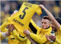  ?? AP ?? Dortmund players hold up the jersey of teammate Marc Bartra after the Bundesliga match against Frankfurt. —
