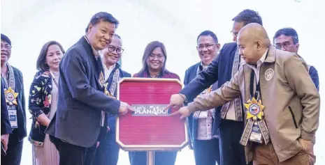  ?? (PHOTO COURTESY OF DHSUD FACEBOOK PAGE) ?? DHSUD Usec. Henry L. Yap (left, foreground) and Asec. Darryl Bryan Villanueva (right) lead the launching of the Planado (Plan & Do) program on Feb. 20, 2024 in Cebu City together with officials from the Philippine Informatio­n Agency, Department of Interior and Local Government, National Economic Developmen­t Authority, Department of Environmen­t and Natural Resources, and Department of Science and Technology.