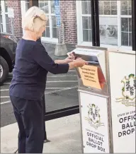  ?? Ken Borsuk / Hearst Connecticu­t Media ?? Greenwich resident Birgitta Longnecker drops off her absentee ballot at Town Hall on Tuesday morning. Town residents have been requesting ballots in record numbers this year and there are drop off locations at Town Hall and the lobby of the police station.