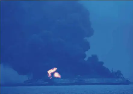 ?? — AFP ?? Serious accident: The Panamanian-flagged tanker is still burning one day after the collision with a cargo ship off the coast of eastern China.