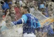  ?? NAM Y. HUH — ASSOCIATED PRESS ?? Cubs’ David Bote gets splashed with Gatorade by his teammates after his game-winning homer against the Reds at Wrigley Field in Chicago on Friday.