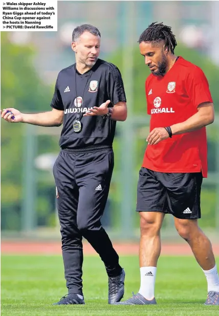  ??  ?? > Wales skipper Ashley Williams in discussion­s with Ryan Giggs ahead of today’s China Cup opener against the hosts in Nanning > PICTURE: David Rawcliffe