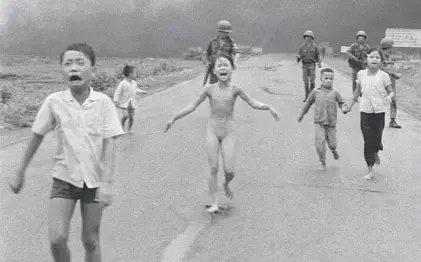  ?? NICK UT/AP ?? In this June 8, 1972, file photo taken by Huynh Cong “Nick” Ut, South Vietnamese forces follow terrified children, including 9-year-old Kim Phuc, center, as they run down Route 1 near Trang Bang after an aerial napalm attack. After making the photo, Ut...