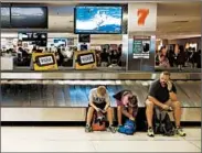  ?? ROB CARR/GETTY ?? Under new rules announced Wednesday, airlines will have to refund bag fees for “substantia­lly” delayed luggage.