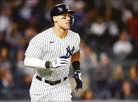  ?? Elsa / Getty Images ?? The Yankees’ Aaron Judge watches his two-run home run as he rounds first base in the third inning against the Guardians on Friday in New York.
