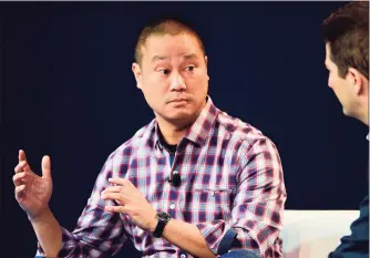  ?? Frederic J. Brown /AFP / Getty Images / TNS ?? ⏩ Above, Tony Hsieh, CEO of Zappos, during an October 2015 interview in Laguna Beach, Calif.