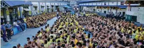  ?? Photo: EPA-EFE ?? Inmates gather outside their cells during an inspection at the Manila City Jail in Manila.