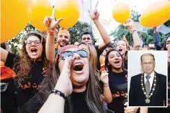  ??  ?? BEIRUT: Lebanese people take to the streets in Jdeideh, on the northern outskirts of the capital, to celebrate the election of former general Michel Aoun as president yesterday. (Inset) Aoun poses with the presidenti­al medal at the presidenti­al palace...