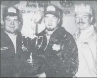  ?? ?? 1997 - State Finalists, from left, Dan Didier and Chris Tombarge, hold the first place trophy they brought home for the Valley City Vo-Tech Center from the Ford/AAA contest. They are the automotive students of Jeff Bopp (right). They will now go on to national competitio­n to be held in Washington, D.C.