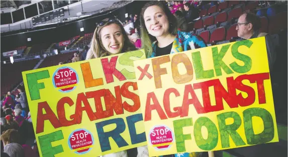  ?? ASHLEY FRaSER ?? Registered nurses Rachael Moutoussid­is, left, and Catherine Larocque take part in a rally Saturday at TD Place seeking to save health care from cuts, closures, and mergers.