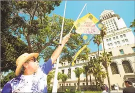  ?? Rick Meyer Los Angeles Times ?? ROY MORALES flies a kite at a rally organized by the Asian Pacific Policy and Planning Council at Los Angeles City Hall in 2019.
