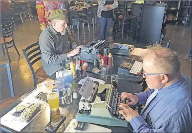  ?? [RUSSELL CONTRERAS/THE ASSOCIATED PRESS PHOTOS] ?? Joe Van Cleave, left, and Rich Boucher try out vintage typewriter­s at a “type-in” in Albuquerqu­e, N.M. “Type-ins” are social gatherings in public places where typewriter fans test different vintage machines.