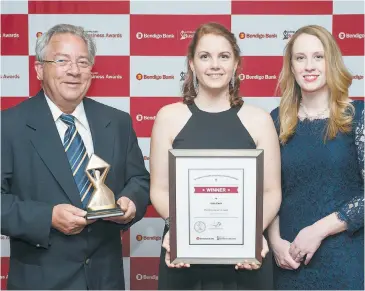  ??  ?? Wayne Portelli, left, and Pieta Reidy, right, of Elite Pack, accept their award for manufactur­ing/export from Kathleen Raymond of Regional Developmen­t Victoria.