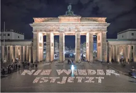  ?? SEBASTIAN GOLLNOW/AP ?? “Never again is now” written in candles at Berlin’s Brandenbur­g Gate during a campaign against right-wing extremism in January.