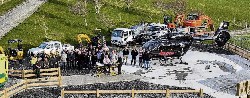  ?? PHOTO: TIM DICKEY/SUPPLIED ?? Many hands . . . Project leaders and emergency service personnel welcome the Otago Regional Rescue Helicopter to Lawrence’s new helipad during a special opening ceremony at Simpson Park on Saturday afternoon.