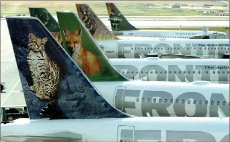  ?? Bloomberg photo by Matthew Staver ?? Frontier Airlines planes stand at their gates at Denver Internatio­nal Airport in 2003.