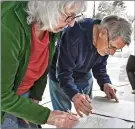  ?? ?? Signal file photo Recently, Patti Martin, left, and Carl Pike sign the Recall George Gascón petition on the corner of Lyons Avenue and Walnut Street in Newhall.