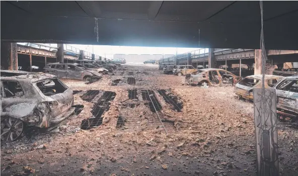  ?? Picture: MERSEYSIDE FIRE AND RESCUE ?? UP IN SMOKE: Burnt-out vehicles at Liverpool Echo Arena carpark, in Liverpool, north-west England. A huge fire destroyed about 1400 vehicles in the carpark. There were no reported injuries in the blaze.