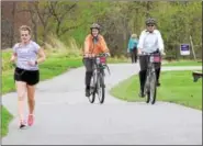  ?? DIGITAL FIRST MEDIA FILE PHOTO ?? Montgomery County Commission­er Val Arkoosh and former commission­er Josh Shapiro ride bikes during the launch of pilot bike share program at the Lower Perkiomen Park in Oaks.