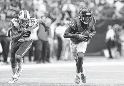  ?? Godofredo A. Vasquez / Staff photograph­er ?? Bills quarterbac­k Nathan Peterman finds Texans cornerback Johnathan Joseph, right, instead of receiver Kelvin Benjamin with an ill-advised pass that Joseph returned 28 yards for a touchdown.