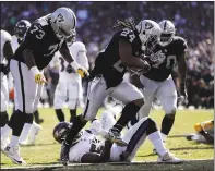  ??  ?? The Raiders’ Marshawn Lynch scores a touchdown against the Ravens over Baltimore’s C.J. Mosley in the third quarter. The score cut Oakland’s deficit to seven points.