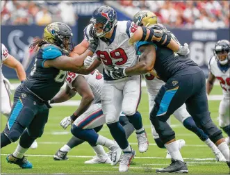  ?? BOB LEVEY / GETTY IMAGES ?? After missing most of last season because of back surgery, J.J. Watt (99) has returned to form and is again demanding double-team blocking.