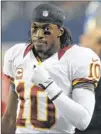  ?? The Cowboys will face red-hot Redskins quarterbac­k Robert Griffin III for a playoff spot. MATT STRASEN / ASSOCIATED PRESS ??