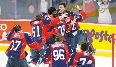  ?? CP PHOTO ?? The Windsor Spitfires celebrate their victory over the Erie Otters in the Memorial Cup final hockey action in Windsor, Ont., on Sunday.