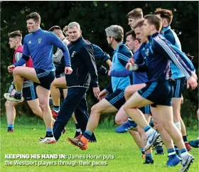  ??  ?? KEEPING HIS HAND IN: James Horan puts the Westport players through their paces