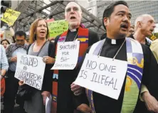  ?? Santiago Mejia / The Chronicle ?? Aryeh Shell (left) and the Revs. Richard Smith and Bruce Reyes-Chow protest outside the Federal Building in S.F.