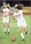  ?? Jeremy Stewart / RN-T ?? Rome High’s Yamileth Rivas (11) moves the ball out of Rome’s half of the field against East Paulding as teammate Janet Hartman (18) looks on during Tuesday’s game.