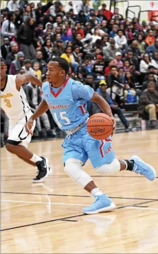  ?? PATRICK HOPKINS — THE NEWS-HERALD ?? VASJ’s Jerry Higgins drives against Cleveland Heights on Dec. 7. The Tigers won the game, 94-81.