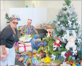  ??  ?? Katikati Lions members Kay Stanbury and Gerald Paterson delivering gifts on Monday.