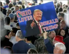  ?? GENE J. PUSKAR - THE ASSOCIATED PRESS ?? In this 2016 photo, a supporter of Republican presidenti­al candidate Donald Trump holds a sign during a plane-side rally at Youngstown-Warren Regional Airport in Vienna, Ohio.