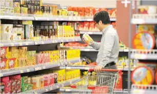  ?? — Reuters ?? A customer shops at a store selling imported goods in Qingdao, Shandong province, China.