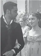  ?? LIAM DANILE/ NETFLIX ?? Regé- Jean Page as the Duke of Hastings and Phoebe Dynevor as Daphne Bridgerton.