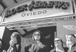  ?? JACOB LANGSTON/STAFF FILE PHOTO ?? Paul Stanley, left, and Gene Simmons of KISS cut the ribbon at their restaurant Rock & Brews in Oviedo in 2015. They’ll open a second Central Florida location on April 24.