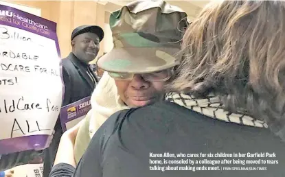  ??  ?? Karen Allen, who cares for six children in her Garfield Park home, is consoled by a colleague after being moved to tears talking about making ends meet.
| FRAN SPIELMAN/ SUN- TIMES