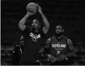  ?? ASSOCIATED PRESS ?? CLEVELAND CAVALIERS’ J.R. SMITH (LEFT) shoots as his teammate LeBron James watches during an NBA basketball practice Wednesday in Oakland, Calif.