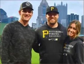  ?? Courtesy of Danielle Bednar ?? Danielle Bednar poses for a portrait at PNC Park with her brother David, center, a pitcher for the Pirates, and her brother Will, who pitches in the San Francisco Giants minor leagues.