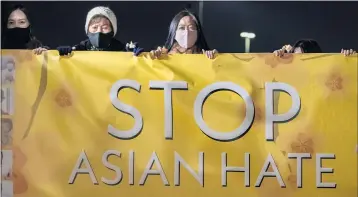  ?? LEONARD ORTIZ — STAFF PHOTOGRAPH­ER ?? Linda Nguyen, right, joins members of the Vietnamese community and others at a rally at Mile Square Park in Fountain Valley on Thursday to decry a surge in hate crimes against Asians. Officials link the rise to the coronaviru­s pandemic.