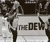  ?? Justin Ford / Getty Images ?? Milwaukee’s Jrue Holiday shoots the game-winning shot against Memphis on Thursday night.