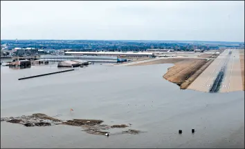  ?? RACHELLE BLAKE/U.S. AIR FORCE ?? Surging strong and up to 7 feet high, the Missouri River floodwater­s poured on to much of Nebraska’s Offutt Air Force Base, which houses the U.S. Strategic Command.