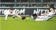  ?? Kevin M. Cox / Associated Press ?? Astros outfielder­s Myles Straw (left) and Kyle Tucker can’t reach a ball that broke up a nohitter.