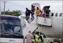  ?? JOSEPH ODELYN — THE ASSOCIATED PRESS ?? Haitians who were deported from the United States deplane at the Toussaint Louverture Internatio­nal Airport, in Port au Prince, Haiti, Sunday, Sep. 19, 2021. Thousands of Haitian migrants have been arriving to Del Rio, Texas, to ask for asylum in the U.S., as authoritie­s begin to deported them to back to Haiti which is in a worse shape than when they left.