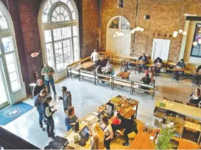  ?? STAFF PHOTO BY TIM OMARZU ?? Customers lined up at lunchtime Monday at Frothy Monkey, a new eatery just inside the main lobby of the historic Choo Choo hotel.