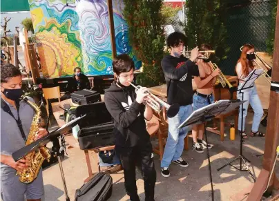  ?? Photos by Arturo Riera ?? Saxophonis­t Niko Kompella and trumpeters Jazzton Blase and Raven La with other members of the Latin Jazz Youth Ensemble of San Francisco. They’ll perform Sunday, Sept. 12, at the Yerba Buena Gardens Festival.