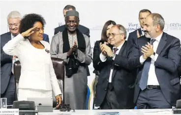  ?? LUDOVIC MARIN / AFP / GETTY IMAGES ?? Michaëlle Jean, outgoing secretary general of la Francophon­ie, salutes colleagues at the 17 th Francophon­e countries summit in Yerevan on Friday. She will be replaced by Louise Mushikiwab­o, Rwanda’s foreign minister.