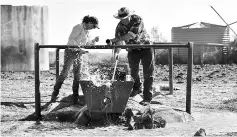  ??  ?? Matt and Sandra checking bore water on their property during a severe and prolonged drought outside the town of Booligal.