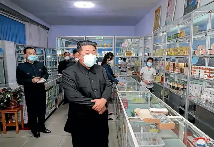  ?? AP ?? North Korean leader Kim Jong Un, centre, visits a pharmacy in Pyongyang on Sunday.